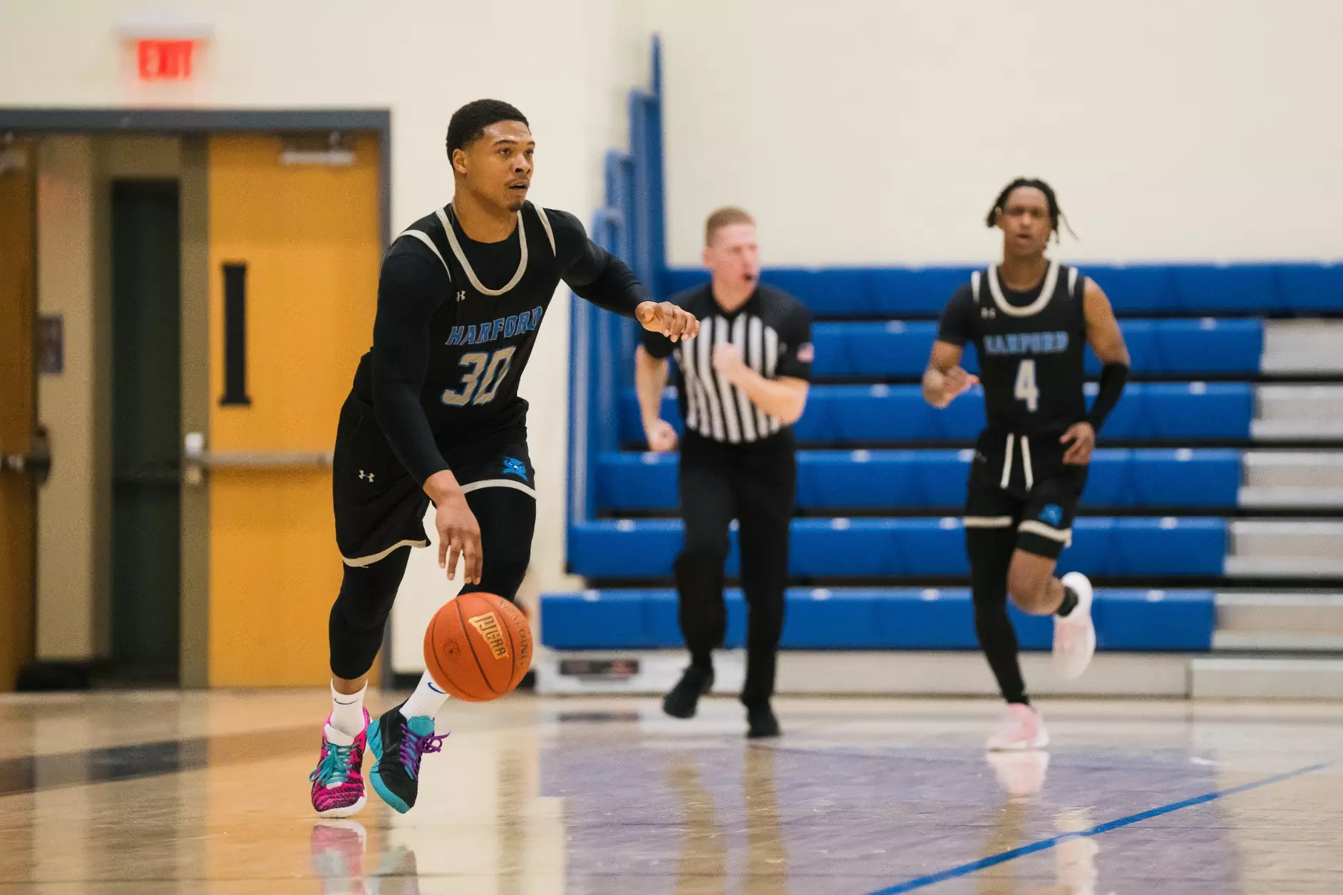 Harford basketball player dribbling in a game